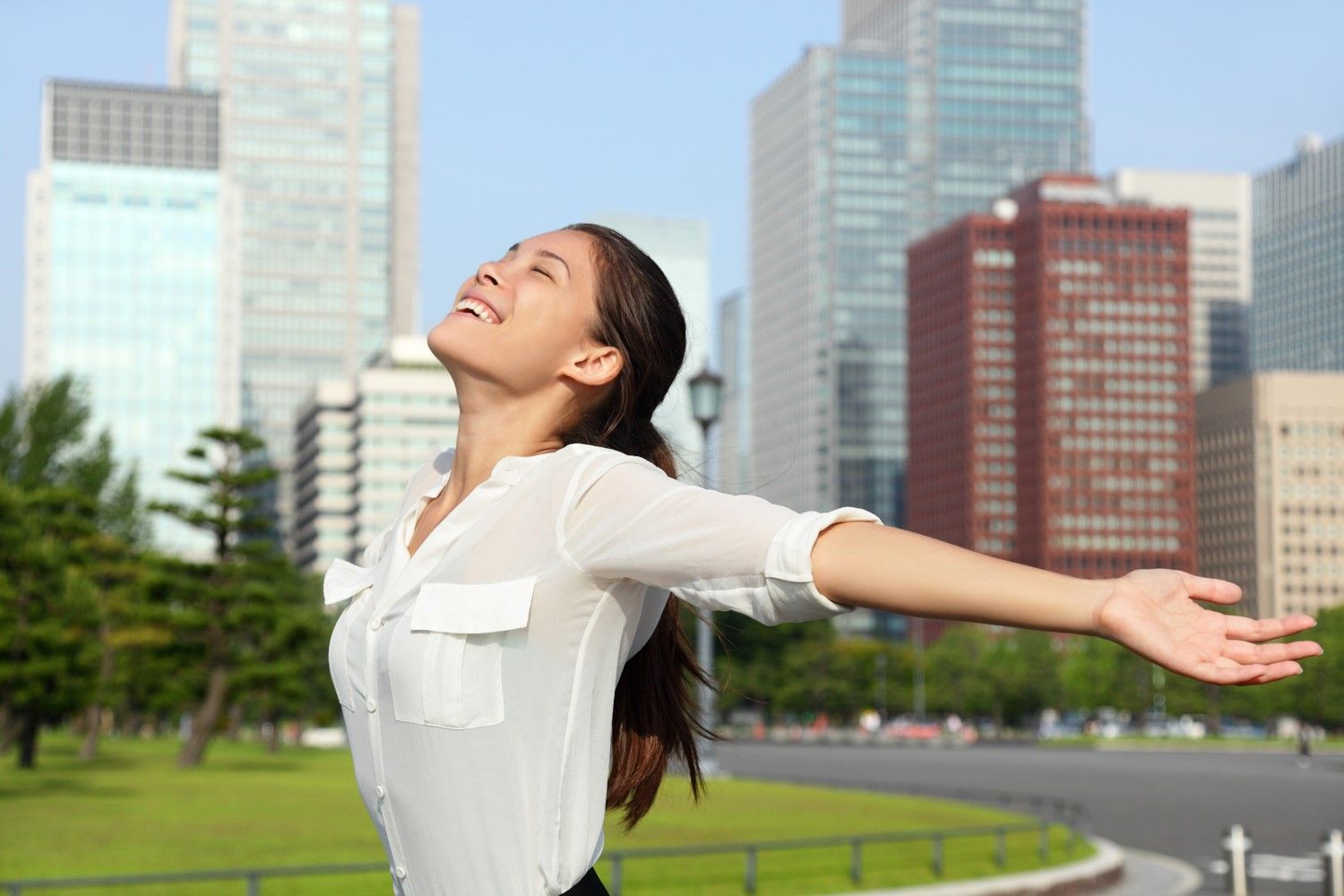 Happy woman in city after EMDR trauma therapy
