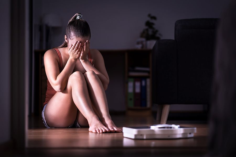Girl crying after seeing her weight