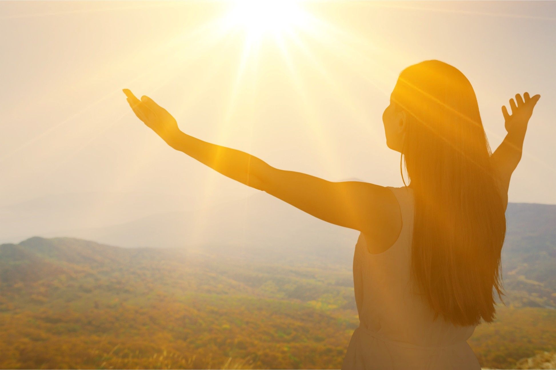A person walking along a bright path, symbolising the start of a recovery journey