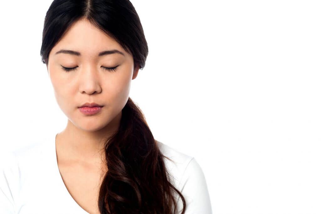 a woman meditating slowly overcoming anxiety