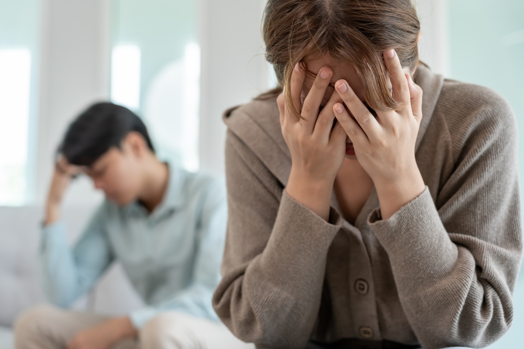 Couple fighting covering their face
