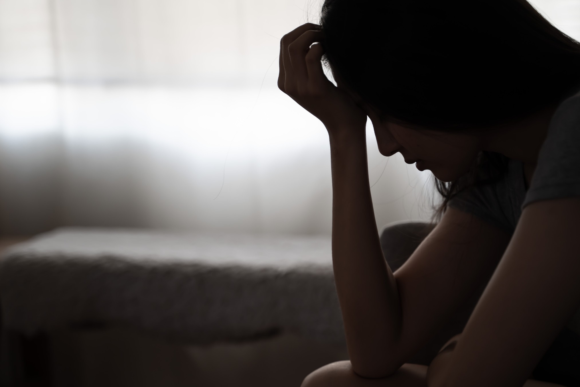 Woman depressed covering her face